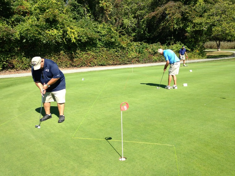 golfers practicing at the putting greens